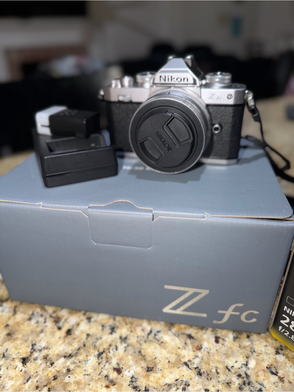Nikon mirrorless camera in silver and black with lens cap